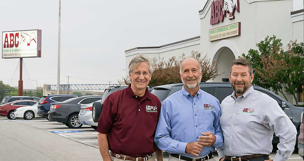 Three brothers stand outside in front of a building named ABC Home & Commercial Services