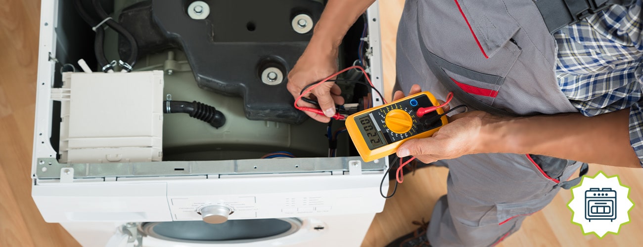 handyman checking washing machine at home